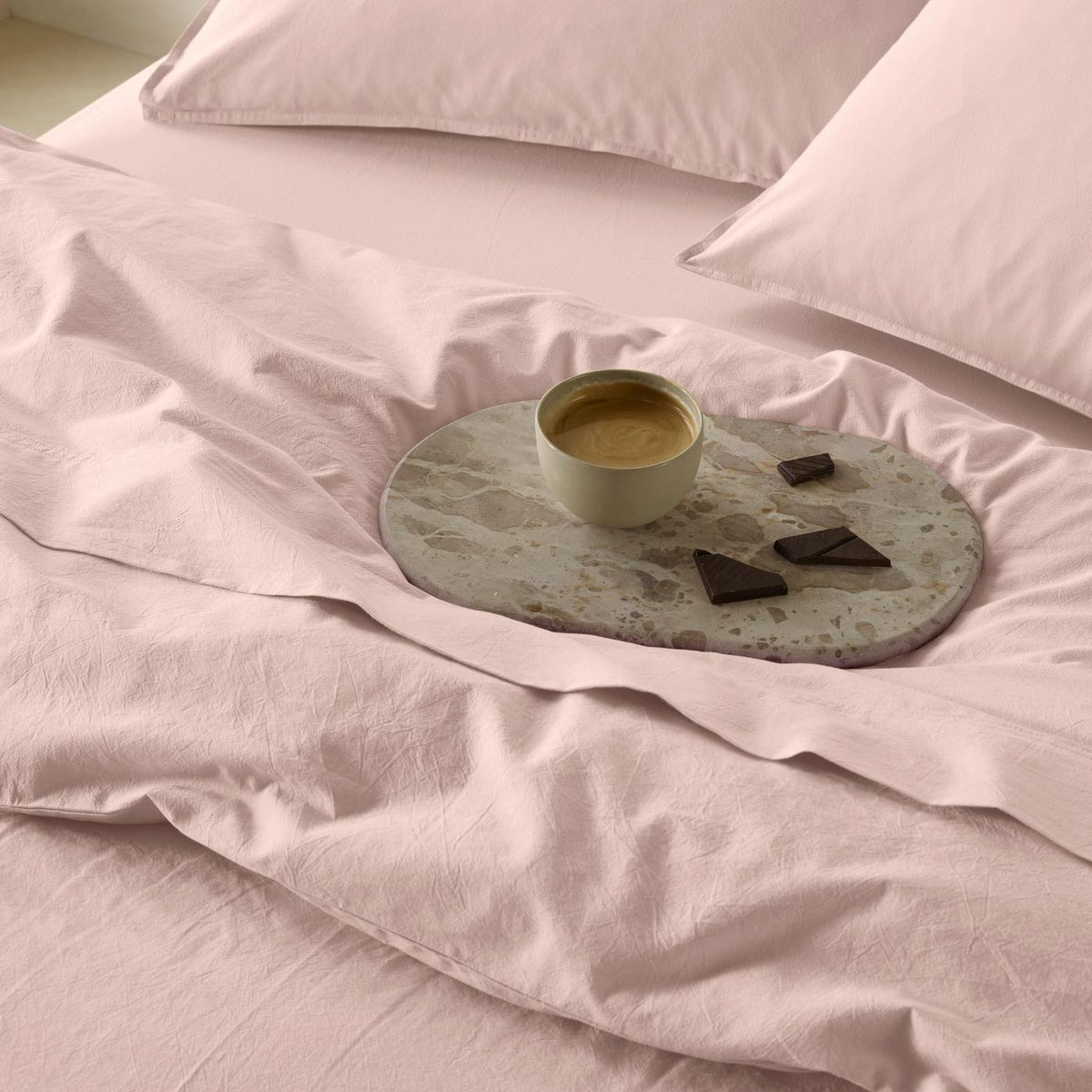 The Honest Label washed cotton bedding in Blush, styled bedroom scene