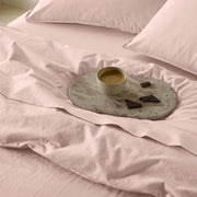 The Honest Label washed cotton bedding in Blush, styled bedroom scene