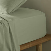 The Honest Label Washed Cotton Fitted Sheet in Sage with green tones fitted sheet close up detail