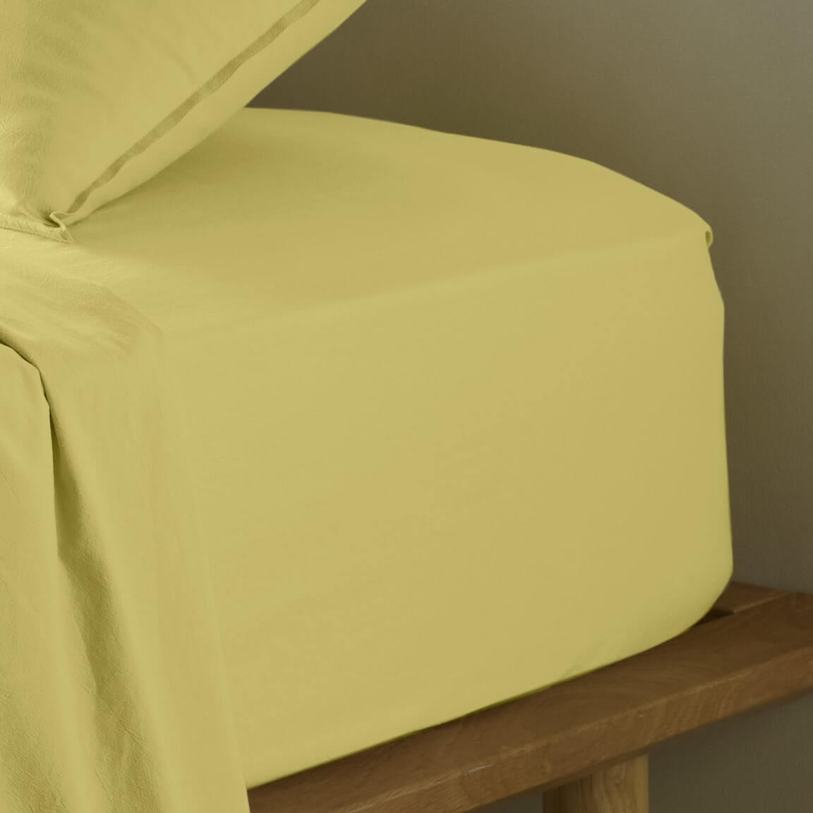 The Honest Label Washed Cotton Fitted Sheet in Butter with yellow tones fitted sheet close up detail
