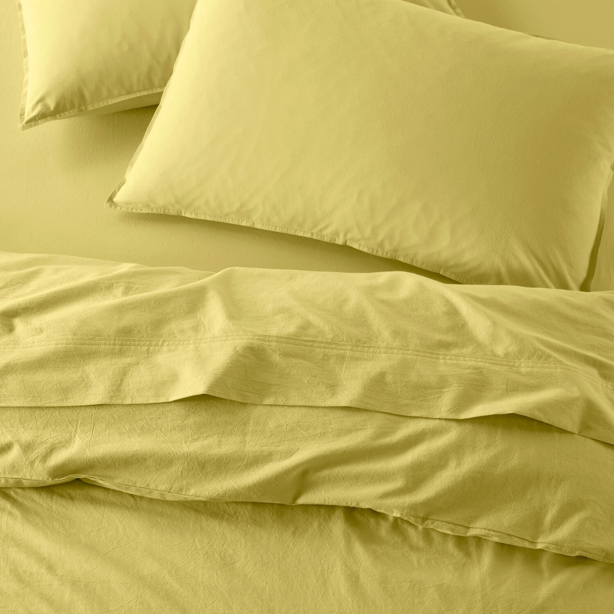 The Honest Label Washed Cotton Standard Pillowcase (2 Pack) in Butter with yellow tones pillowcase top view