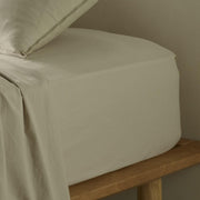 The Honest Label Washed Cotton Fitted Sheet in Flax with beige tones fitted sheet close up detail