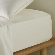The Honest Label Washed Cotton Fitted Sheet in White with white tones fitted sheet close up detail
