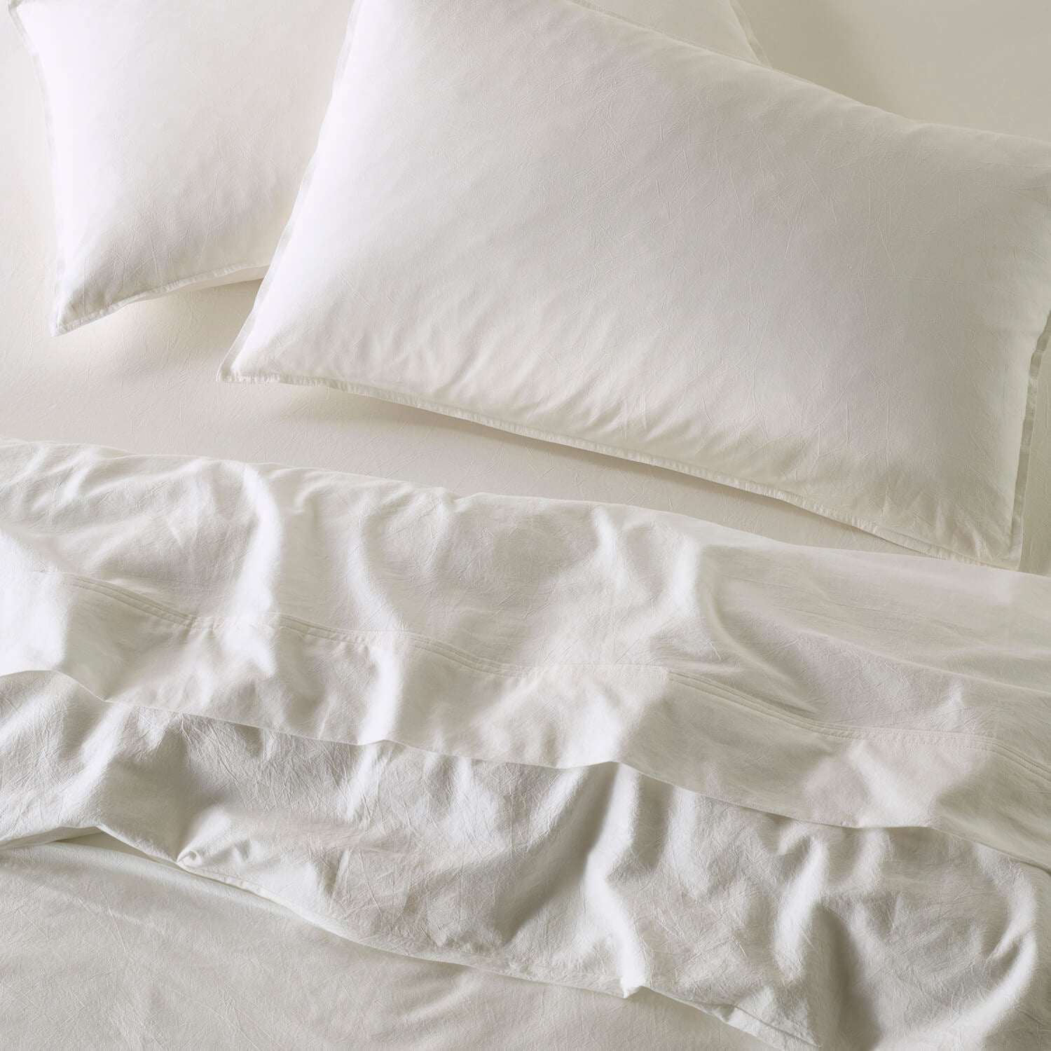 The Honest Label Washed Cotton Standard Pillowcase (2 Pack) in White with white tones pillowcase top view