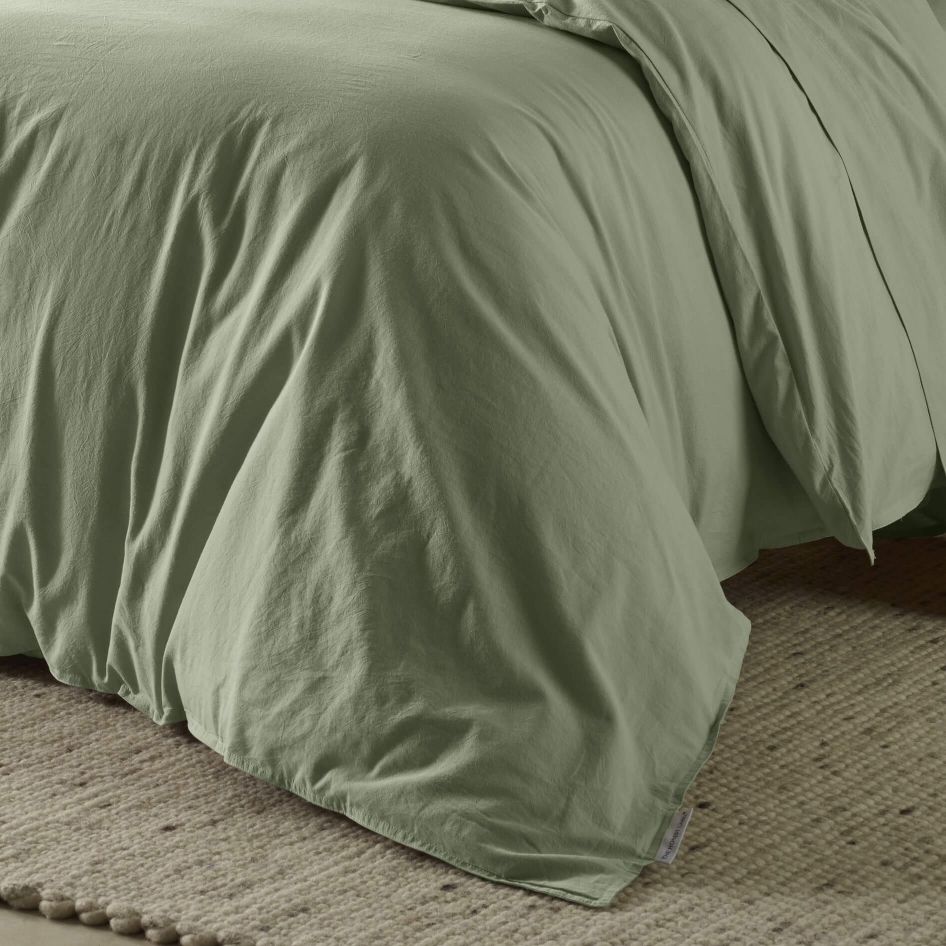 The Honest Label Washed Cotton Quilt Cover in Sage with green tones quilt cover close up detail THL product image 2