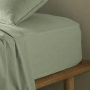 The Honest Label Washed Cotton Fitted Sheet in Sage with green tones fitted sheet close up detail