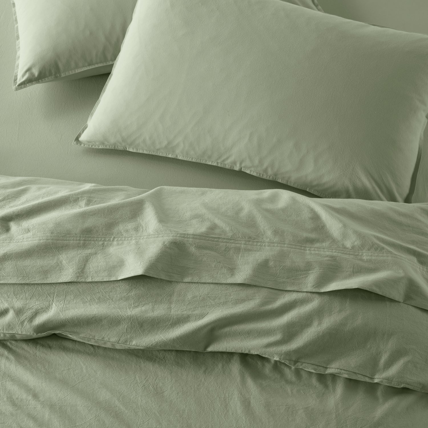 The Honest Label Washed Cotton Standard Pillowcase (2 Pack) in Sage with green tones pillowcase top view