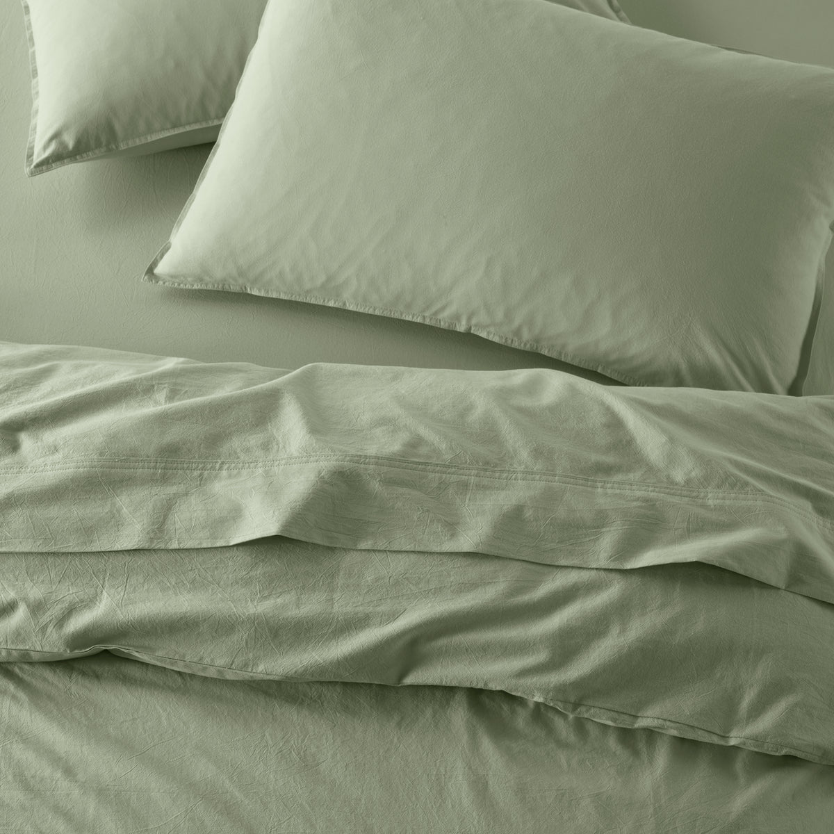 The Honest Label Washed Cotton Standard Pillowcase (2 Pack) in Sage with green tones pillowcase top view