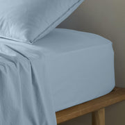 The Honest Label Washed Cotton Fitted Sheet in Skye with blue tones fitted sheet close up detail