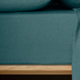The Honest Label Pure Linen Fitted Sheet in Teal with green tones fitted sheet close up detail