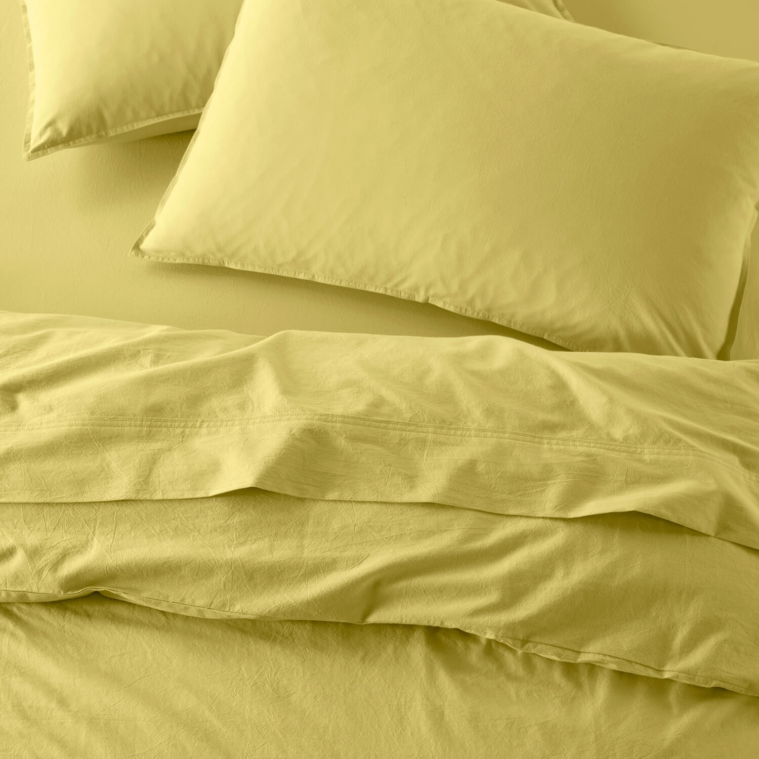 The Honest Label Washed Cotton Flat Sheet in Butter with yellow tones flat sheet top view