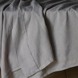 The Honest Label Pure Linen Flat Sheet in Light Grey with grey tones flat sheet close up detail